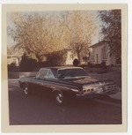 1964 Dodge vehicle parked in residential neighborhood.